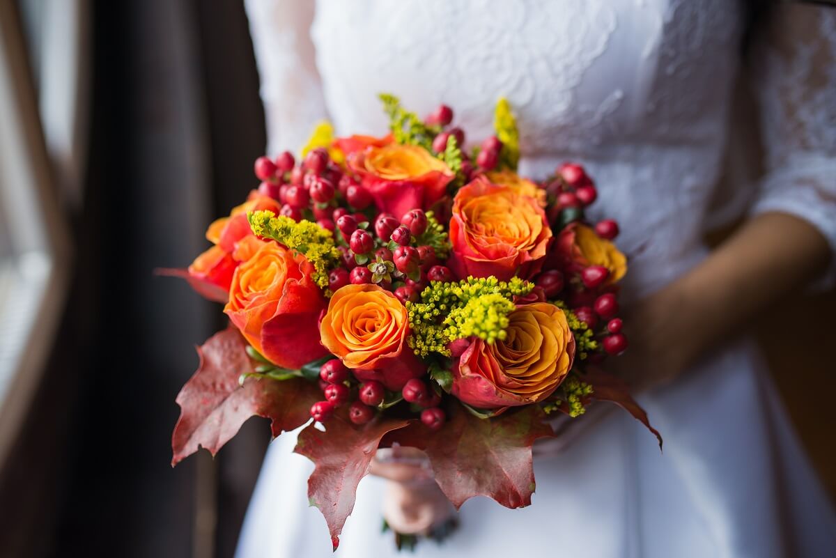 Bride holding wedding Colorful bouquet of autumn flowers